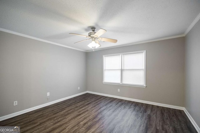 spare room featuring dark wood finished floors, ornamental molding, a ceiling fan, a textured ceiling, and baseboards