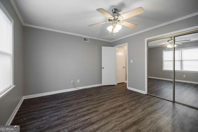 2505 Broad St W Unit 713, Athens, GA 30606 - unfurnished bedroom with dark wood finished floors, crown molding, a ceiling fan, and a closet