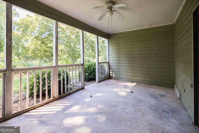 unfurnished sunroom with a ceiling fan