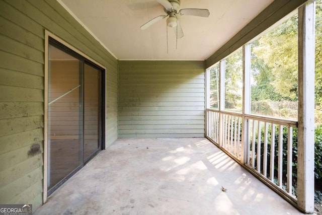 unfurnished sunroom with ceiling fan