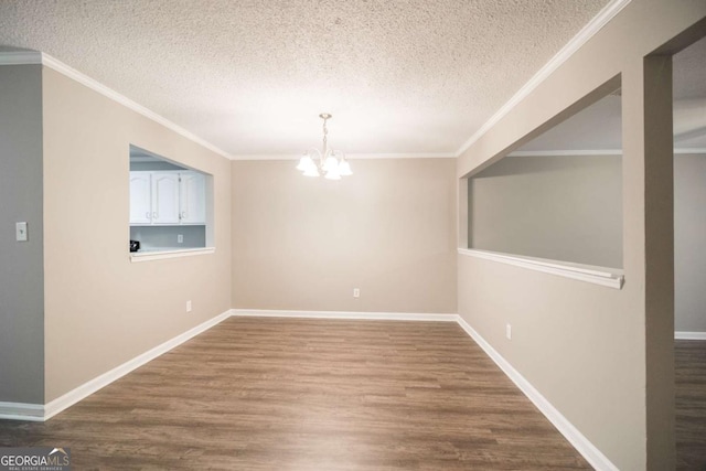 unfurnished dining area with a notable chandelier, crown molding, and wood finished floors