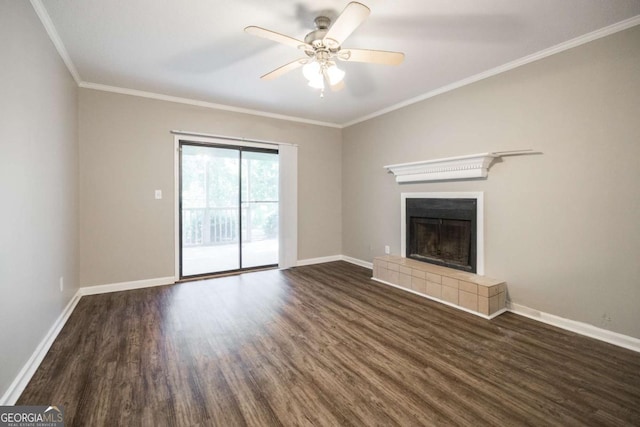 unfurnished living room featuring crown molding, a fireplace, dark wood finished floors, and baseboards