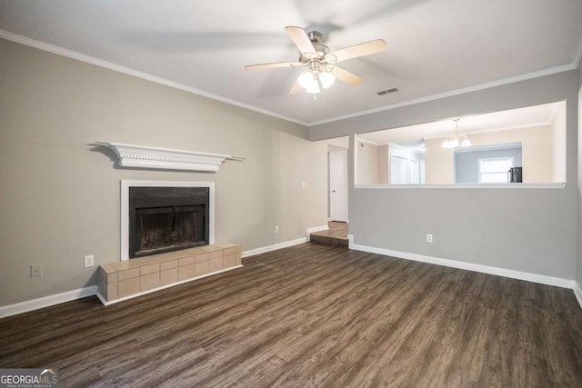 unfurnished living room featuring a fireplace, ornamental molding, and wood finished floors