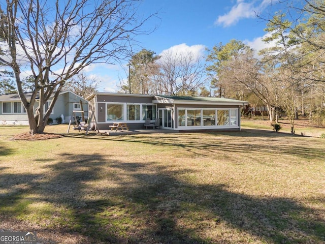 exterior space featuring a lawn and a sunroom