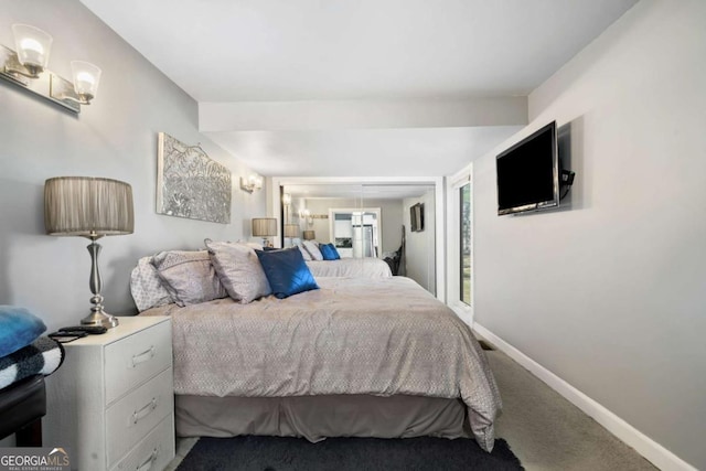 carpeted bedroom with baseboards and a closet