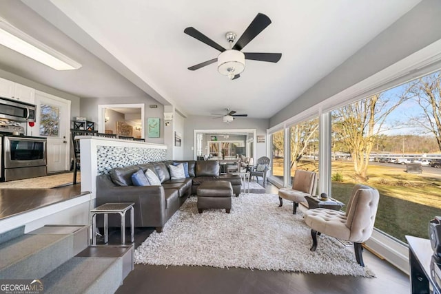 living area featuring a ceiling fan and wood finished floors