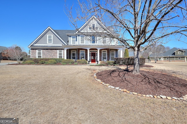 view of front facade featuring stone siding and covered porch