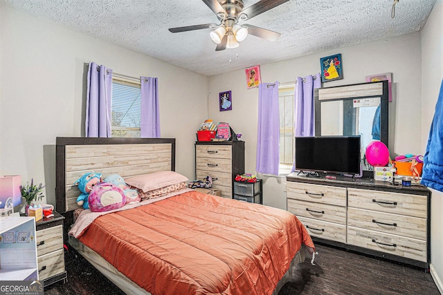 bedroom featuring a textured ceiling, dark wood-type flooring, multiple windows, and a ceiling fan