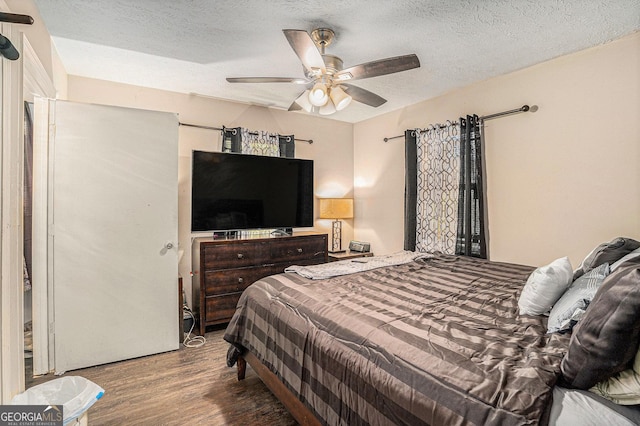 bedroom with ceiling fan, a textured ceiling, and wood finished floors