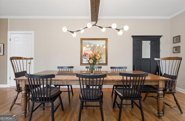 dining space with beamed ceiling, wood finished floors, baseboards, and ornamental molding