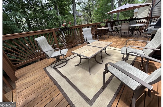 wooden terrace featuring outdoor dining area