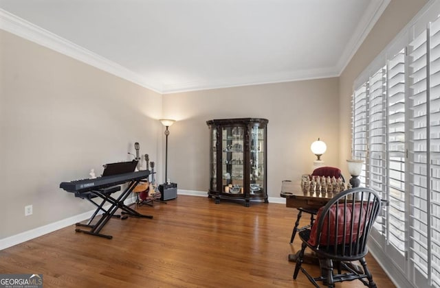 office space with baseboards, wood finished floors, and crown molding