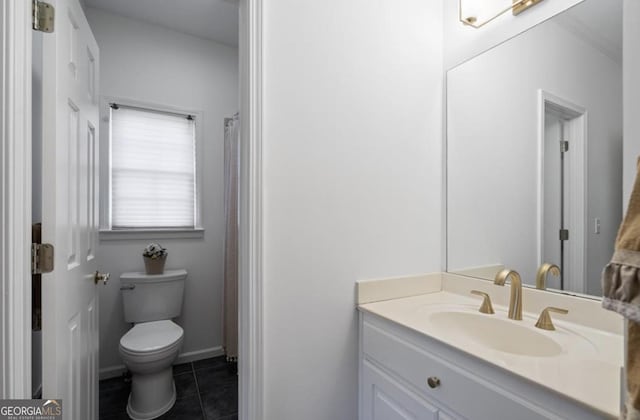 bathroom featuring tile patterned floors, toilet, and vanity