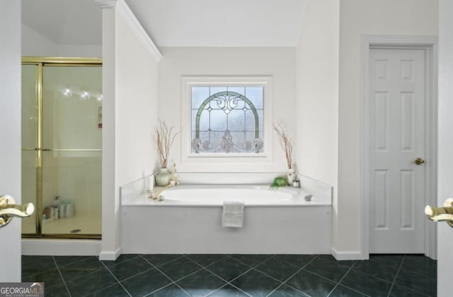 bathroom featuring tile patterned flooring, a stall shower, and a garden tub