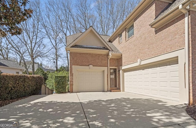 exterior space featuring brick siding and concrete driveway