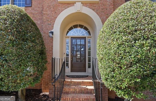 doorway to property with brick siding