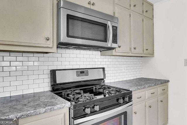 kitchen with appliances with stainless steel finishes and decorative backsplash