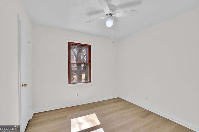 spare room featuring ceiling fan, wood finished floors, and baseboards