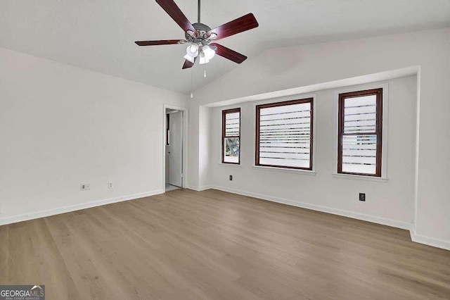 unfurnished bedroom featuring lofted ceiling, a ceiling fan, baseboards, and wood finished floors