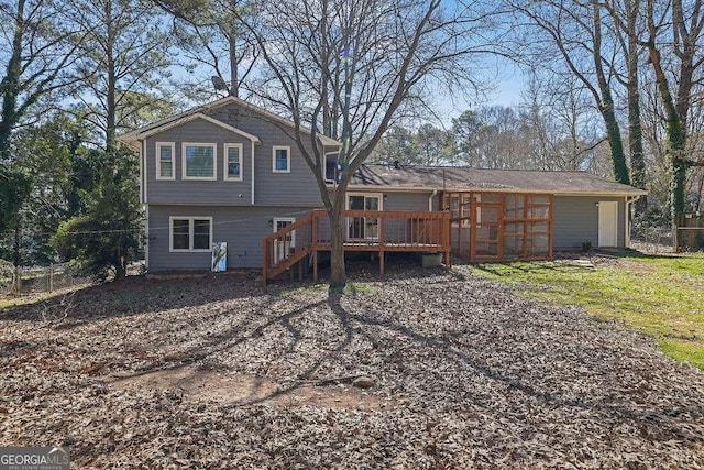 back of property with stairway, fence, and a deck