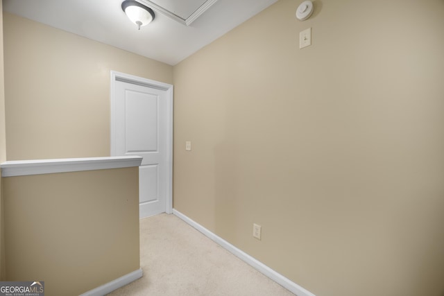 hall with light carpet and baseboards