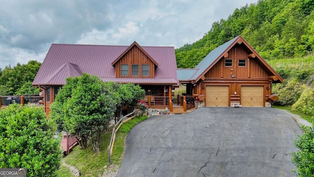 103 Wisteria Dr, Murphy, NC 28906 - cabin featuring a garage, driveway, metal roof, and covered porch