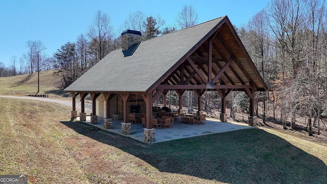 surrounding community with a patio area, a lawn, and a gazebo