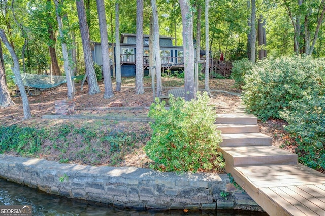 view of yard featuring a deck with water view