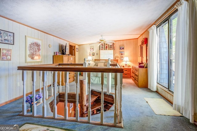 interior space with carpet floors, a textured ceiling, and crown molding