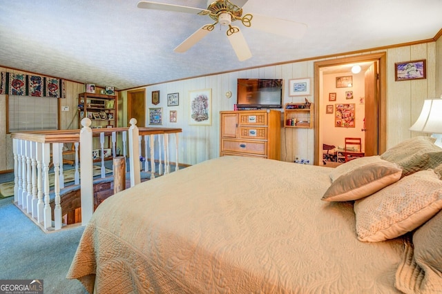 carpeted bedroom with wood walls and ornamental molding