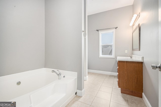 full bathroom with tile patterned flooring, a garden tub, vanity, and baseboards