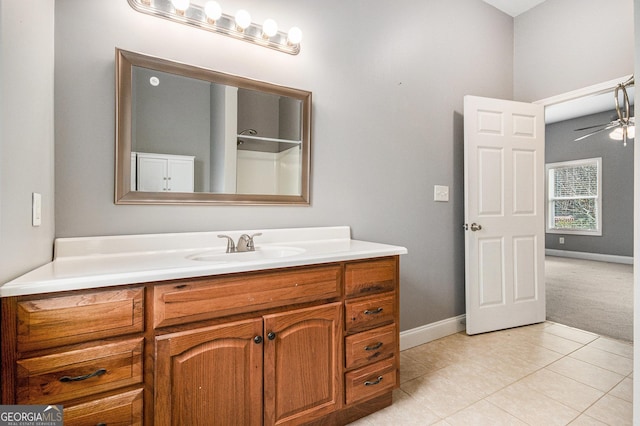 bathroom featuring baseboards, tile patterned flooring, vanity, and a ceiling fan