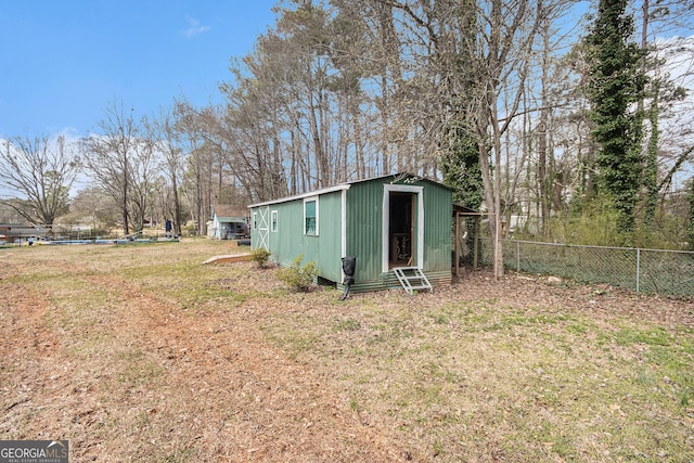 view of outdoor structure with fence and an outdoor structure