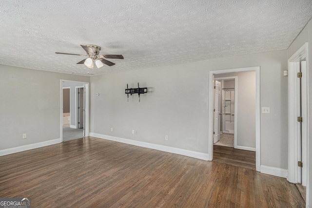 interior space featuring a textured ceiling, wood finished floors, a ceiling fan, and baseboards