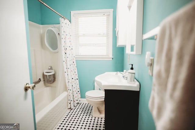 full bath with toilet, tile patterned floors, shower / bathtub combination with curtain, and vanity