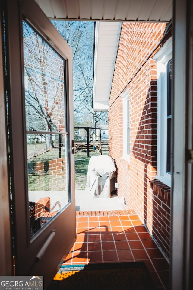 interior space featuring brick wall