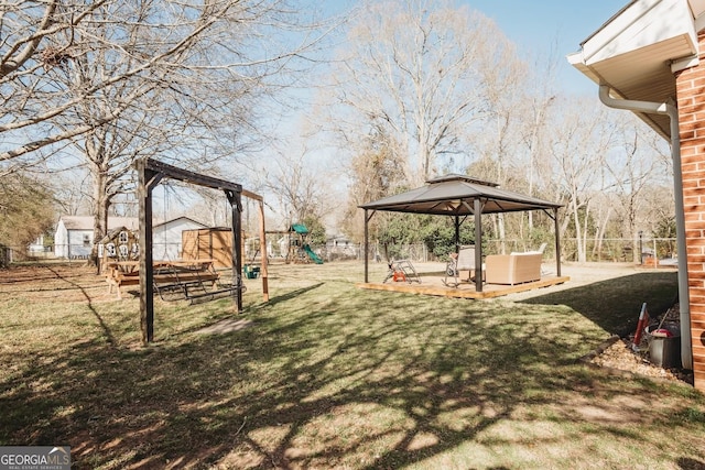 view of yard with a patio, fence, a playground, and a gazebo