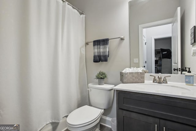 bathroom with toilet, curtained shower, and vanity