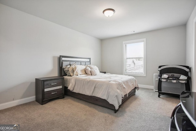 bedroom with visible vents, baseboards, and light colored carpet