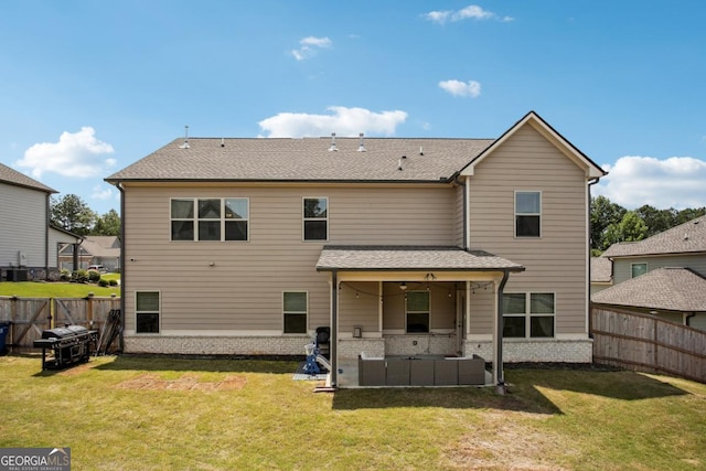 rear view of property featuring a patio area, a fenced backyard, a lawn, and brick siding