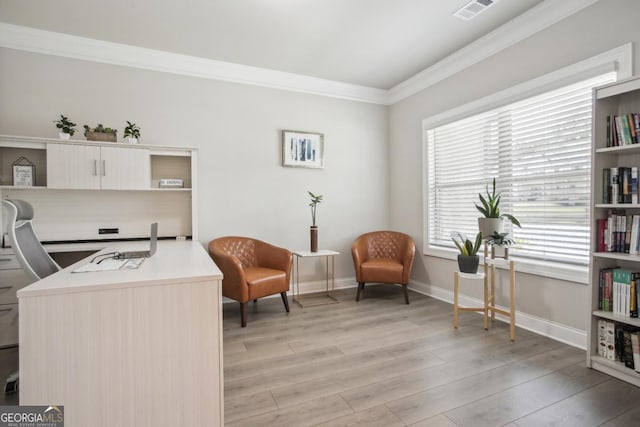 living area with ornamental molding, baseboards, visible vents, and light wood finished floors