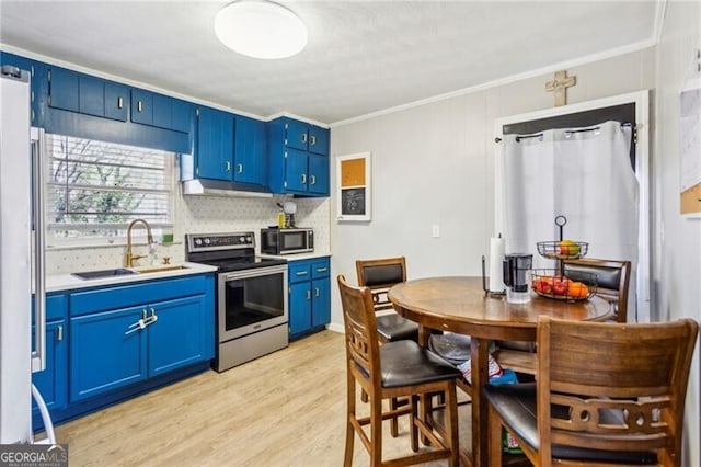 kitchen featuring blue cabinets, stainless steel electric range, light countertops, light wood-type flooring, and a sink