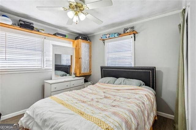 bedroom with crown molding, ceiling fan, baseboards, and wood finished floors