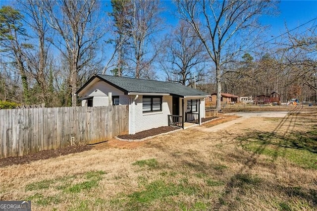 view of outbuilding featuring fence