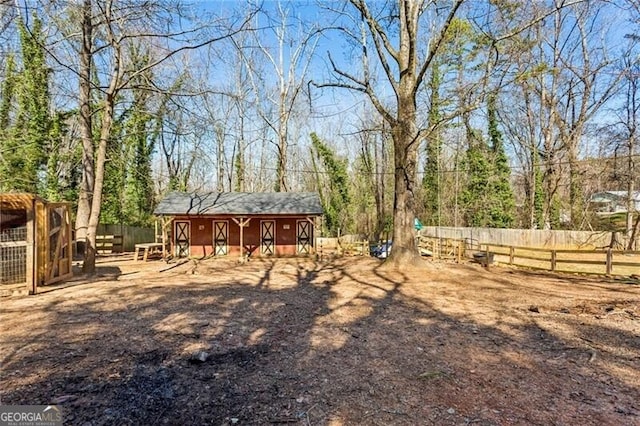 view of yard with an outdoor structure and fence