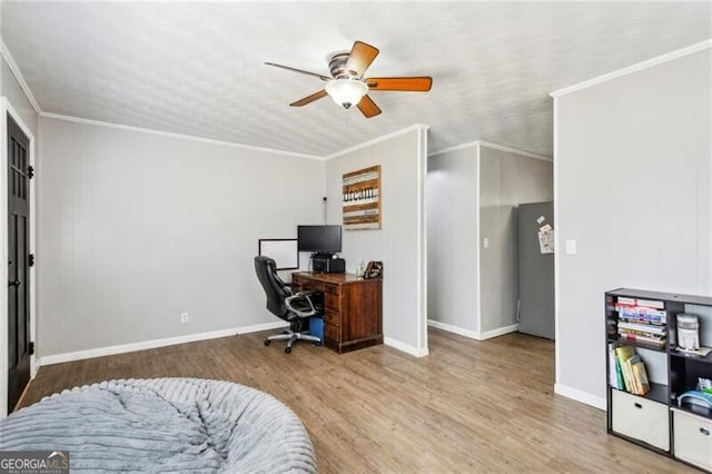 home office with ceiling fan, crown molding, baseboards, and wood finished floors