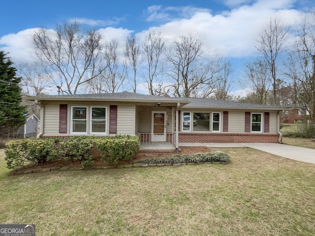 ranch-style home featuring concrete driveway, brick siding, and a front lawn