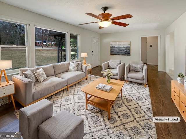 living room featuring ceiling fan, a textured ceiling, wood finished floors, and baseboards