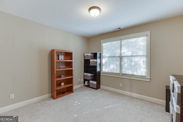 misc room featuring carpet flooring, visible vents, and baseboards