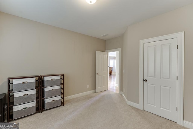 unfurnished bedroom with carpet, visible vents, and baseboards